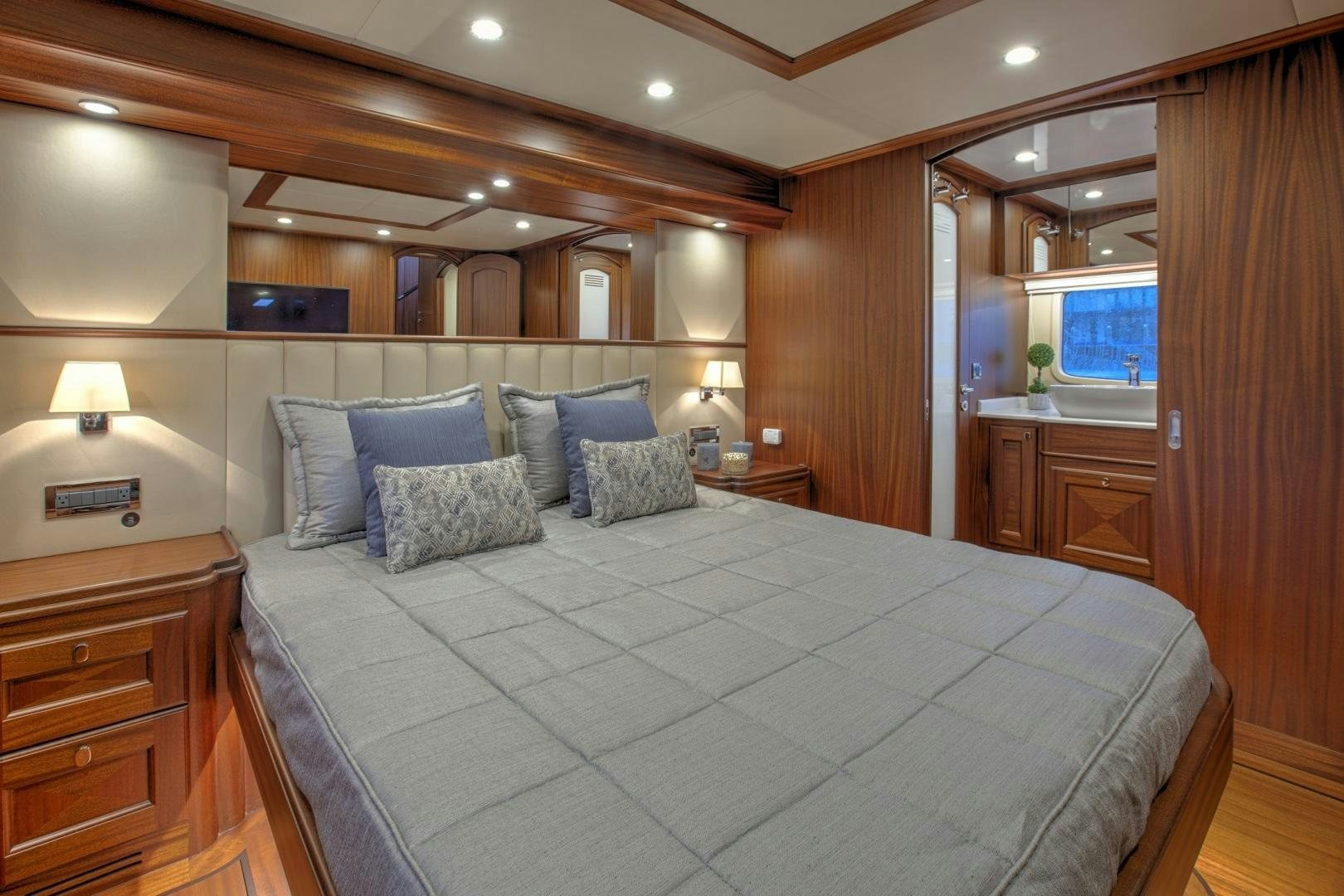 a large bedroom with a large bed aboard 67 CRUISER Yacht for Sale