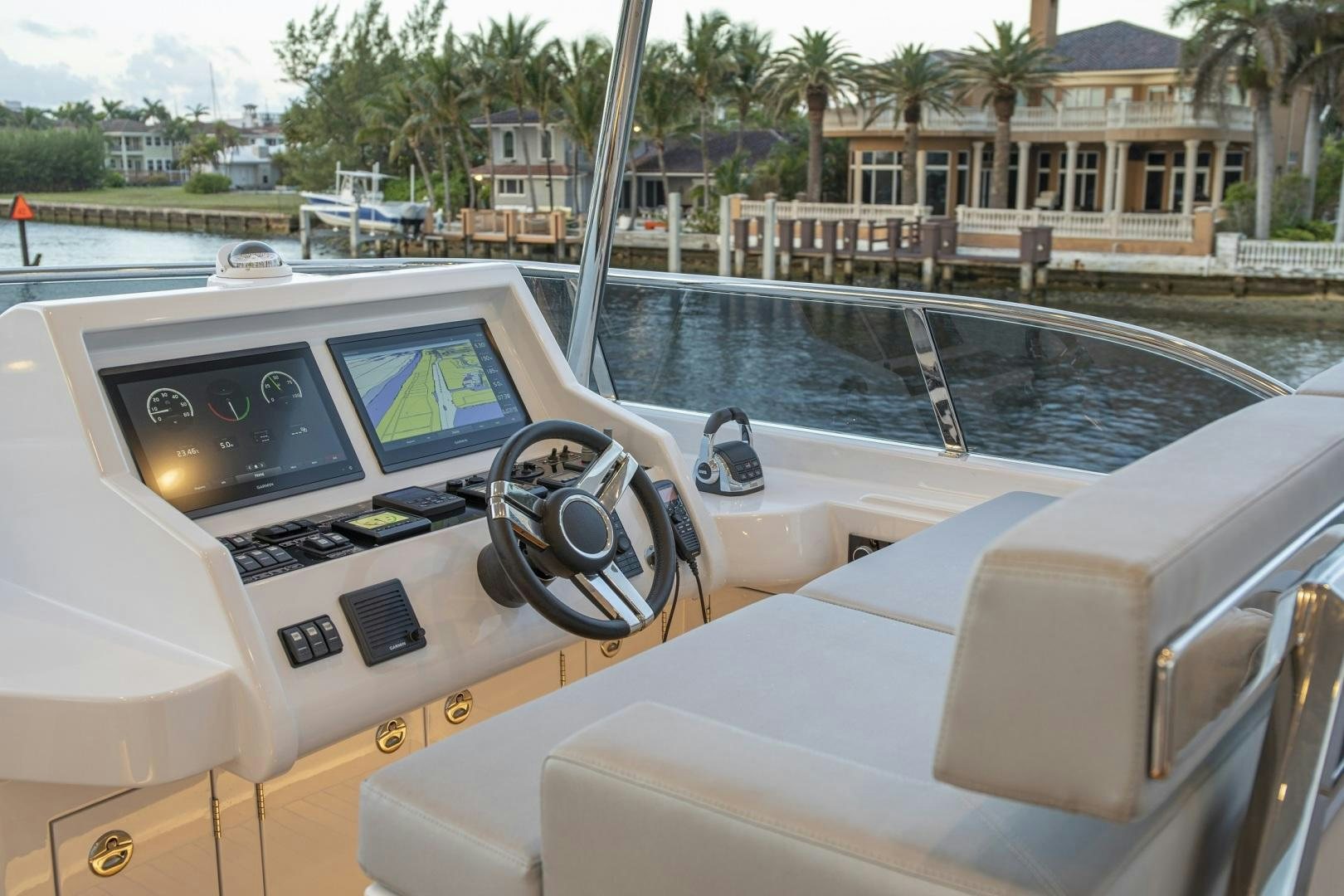 a boat with a steering wheel and a boat on the water aboard 67 CRUISER Yacht for Sale