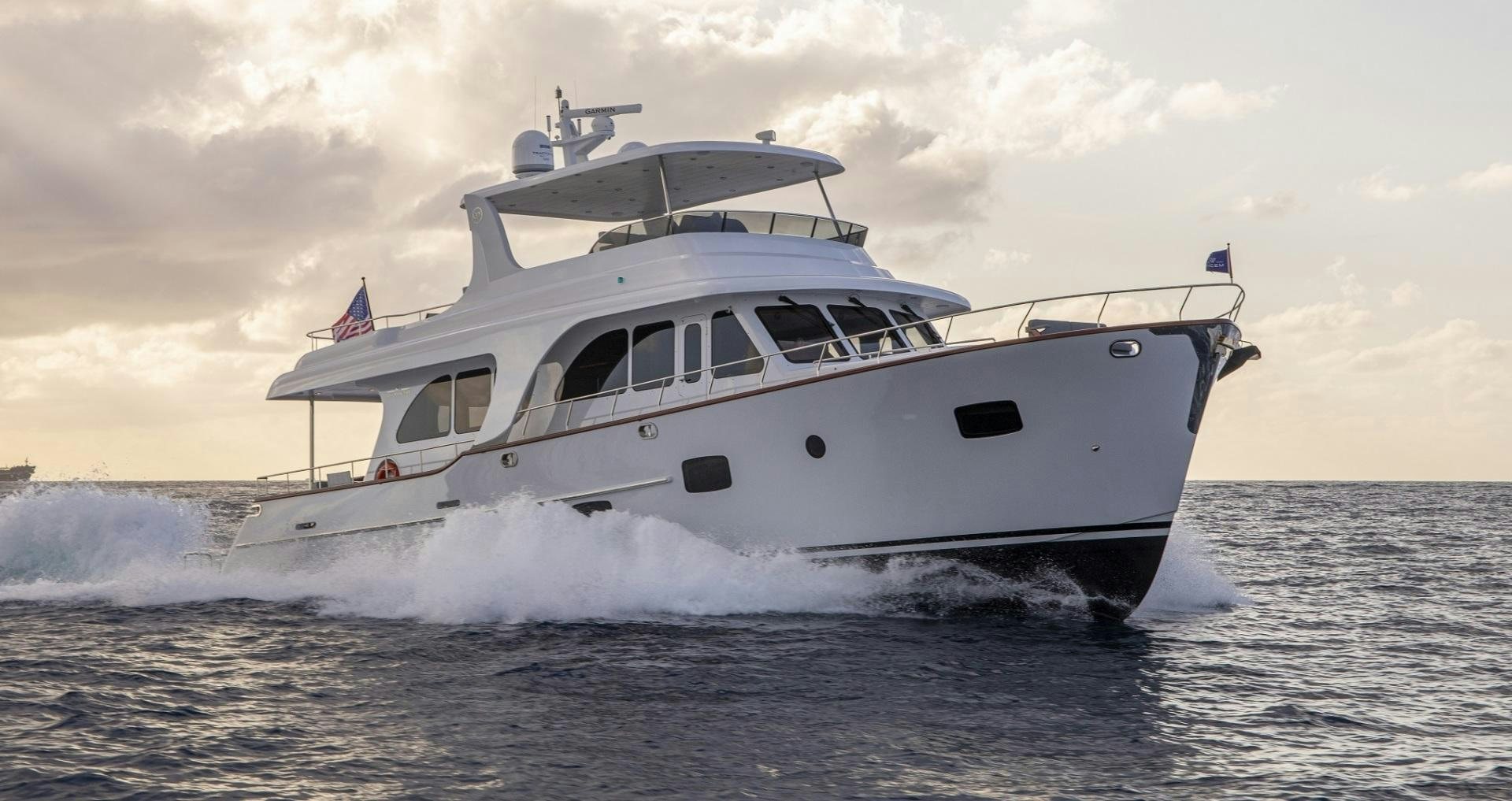 a white boat on the water aboard 67 CRUISER Yacht for Sale