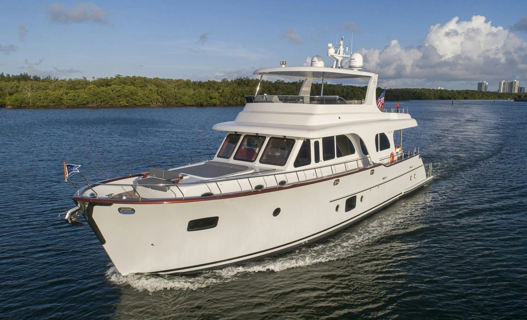 a white boat on the water aboard 67 CRUISER Yacht for Sale