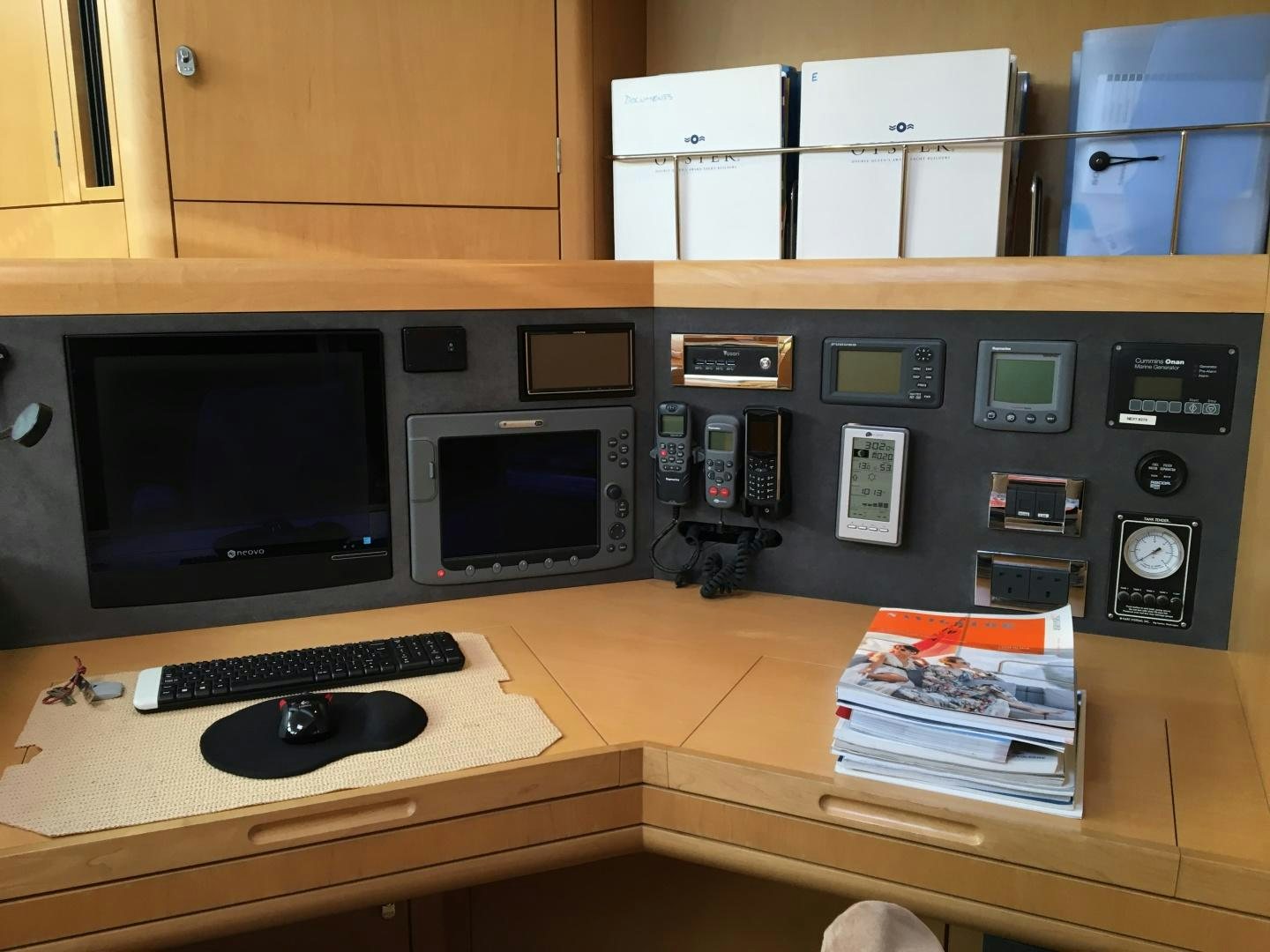 a computer desk with a monitor and keyboard aboard isnl Yacht for Sale