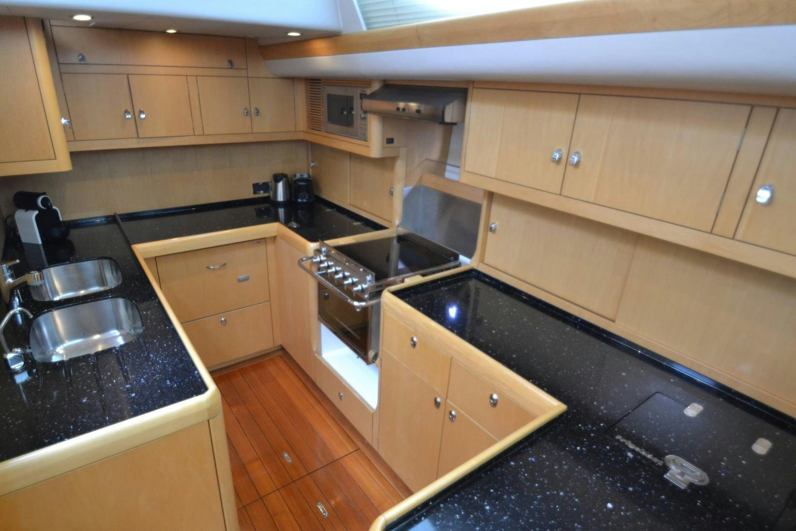 a kitchen with a stove and cabinets aboard isnl Yacht for Sale