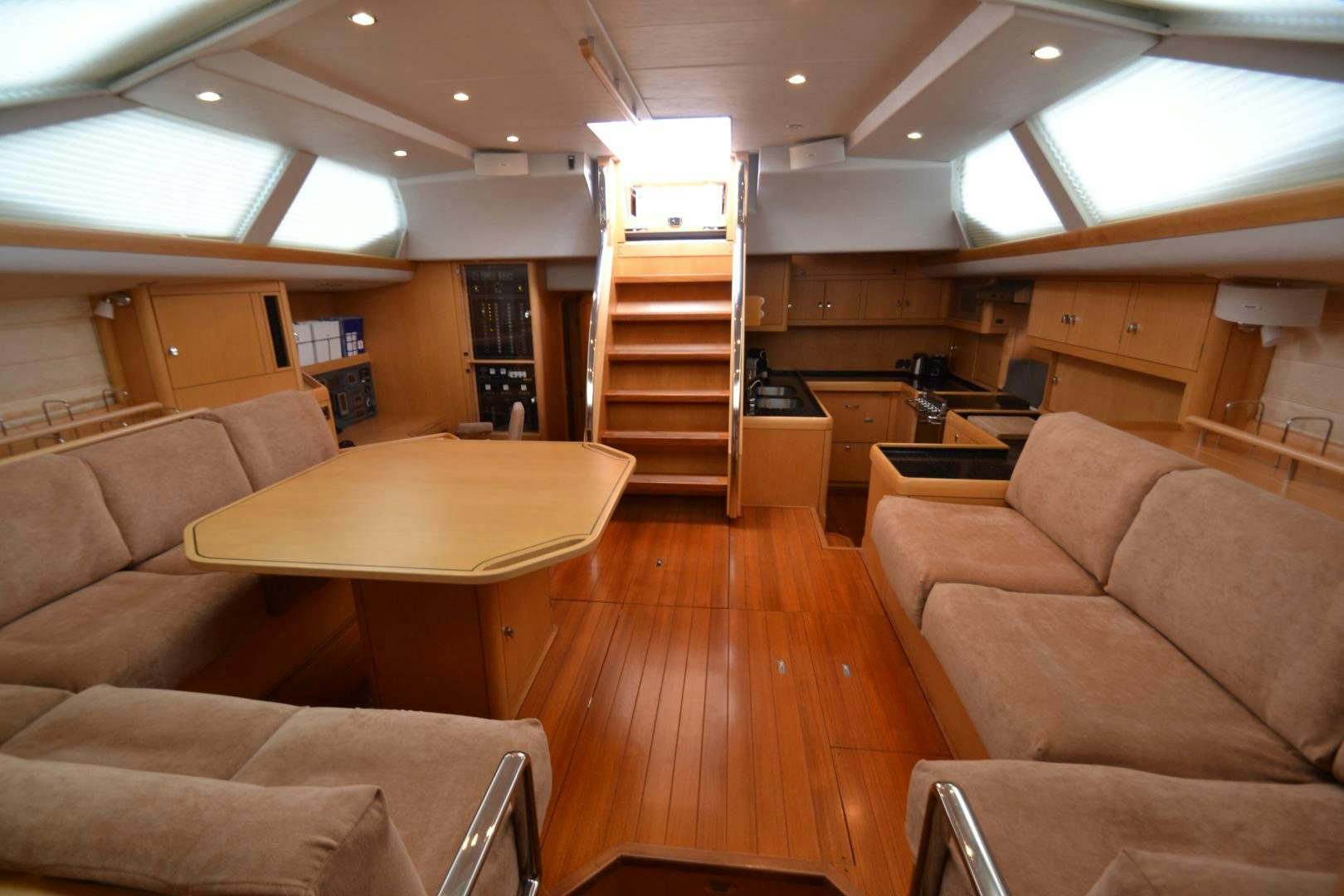 a room with a couch and a table and a staircase aboard isnl Yacht for Sale