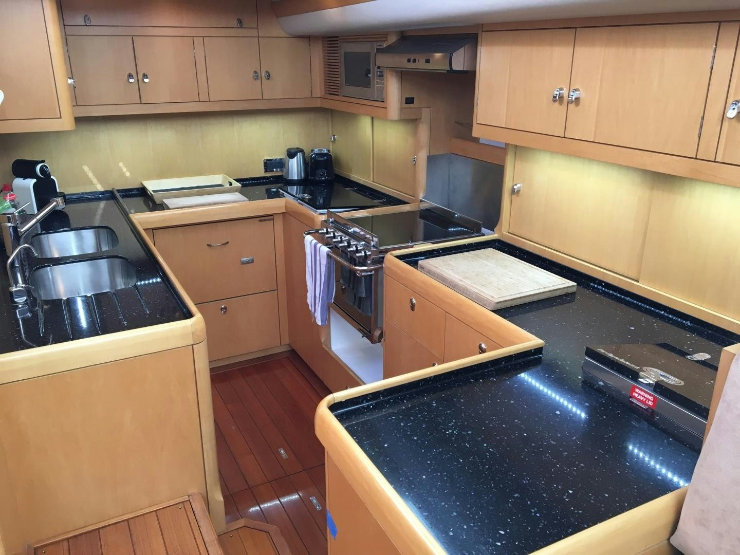 a kitchen with a black counter top aboard isnl Yacht for Sale