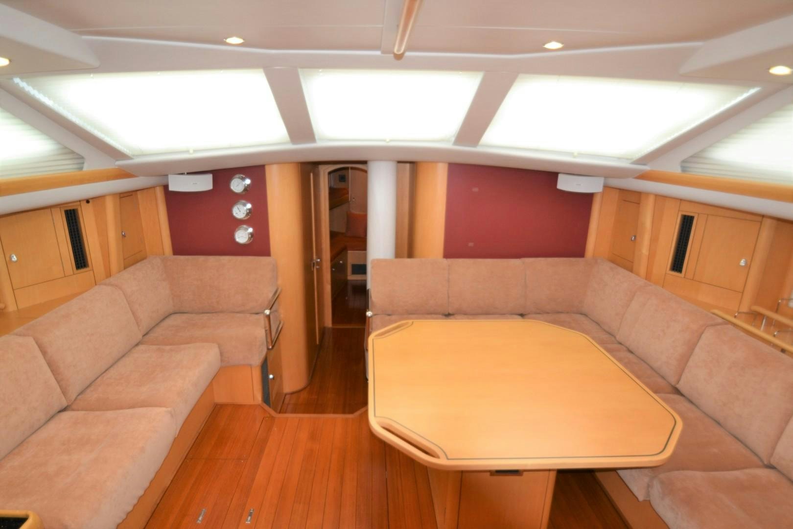 a room with couches and a table aboard isnl Yacht for Sale