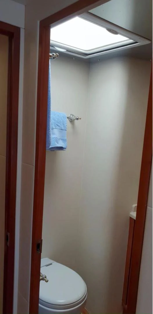 a bathroom with a toilet and a window aboard BOUKI Yacht for Sale