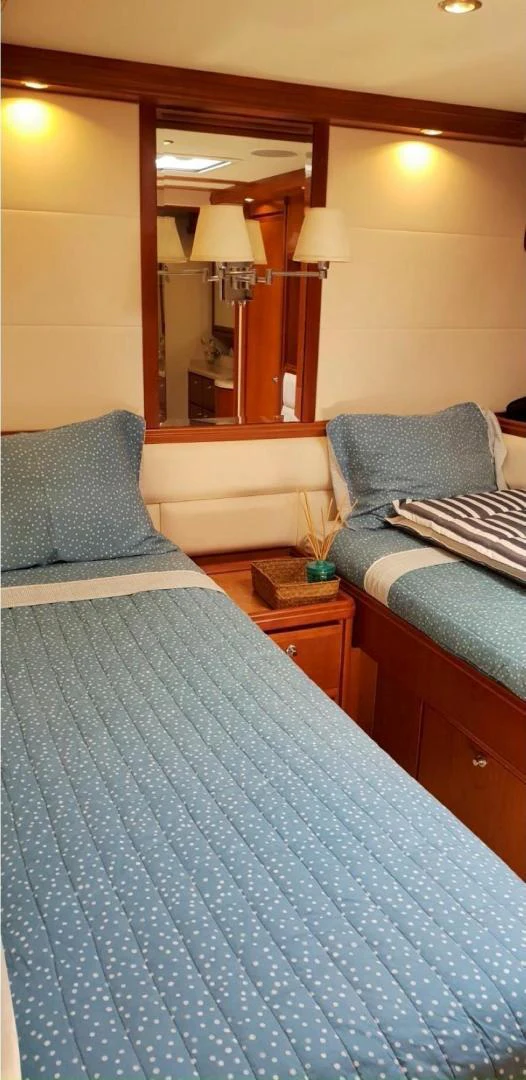 a bed with a blue blanket aboard BOUKI Yacht for Sale
