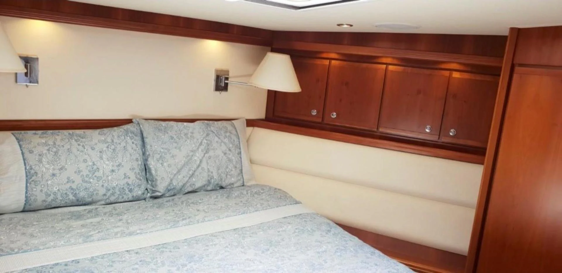 a bed with white sheets aboard BOUKI Yacht for Sale