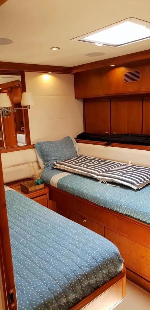 a bedroom with a bed and a desk aboard BOUKI Yacht for Sale