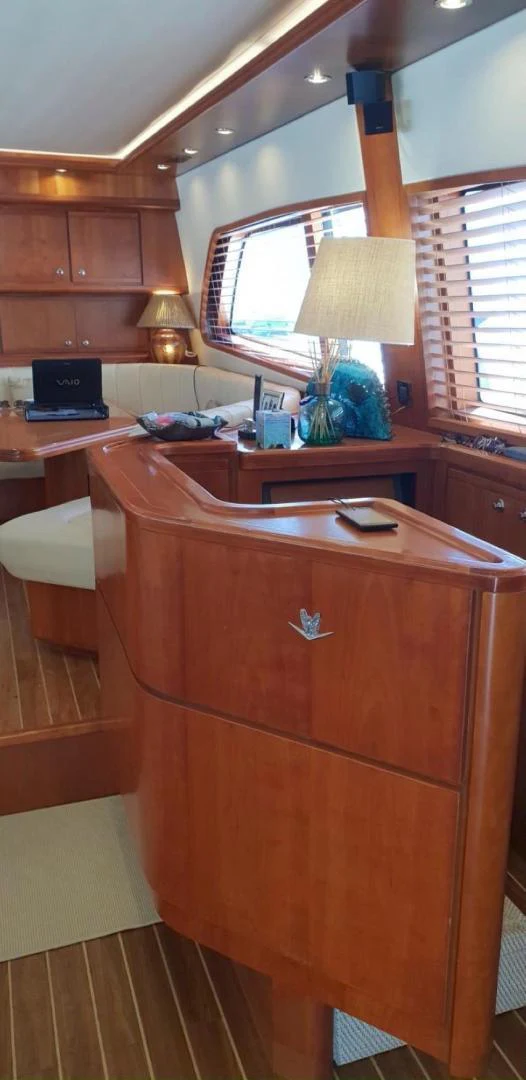 a wooden cabinet with a lamp on it aboard BOUKI Yacht for Sale