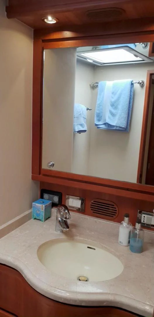 a bathroom with a mirror and a sink aboard BOUKI Yacht for Sale