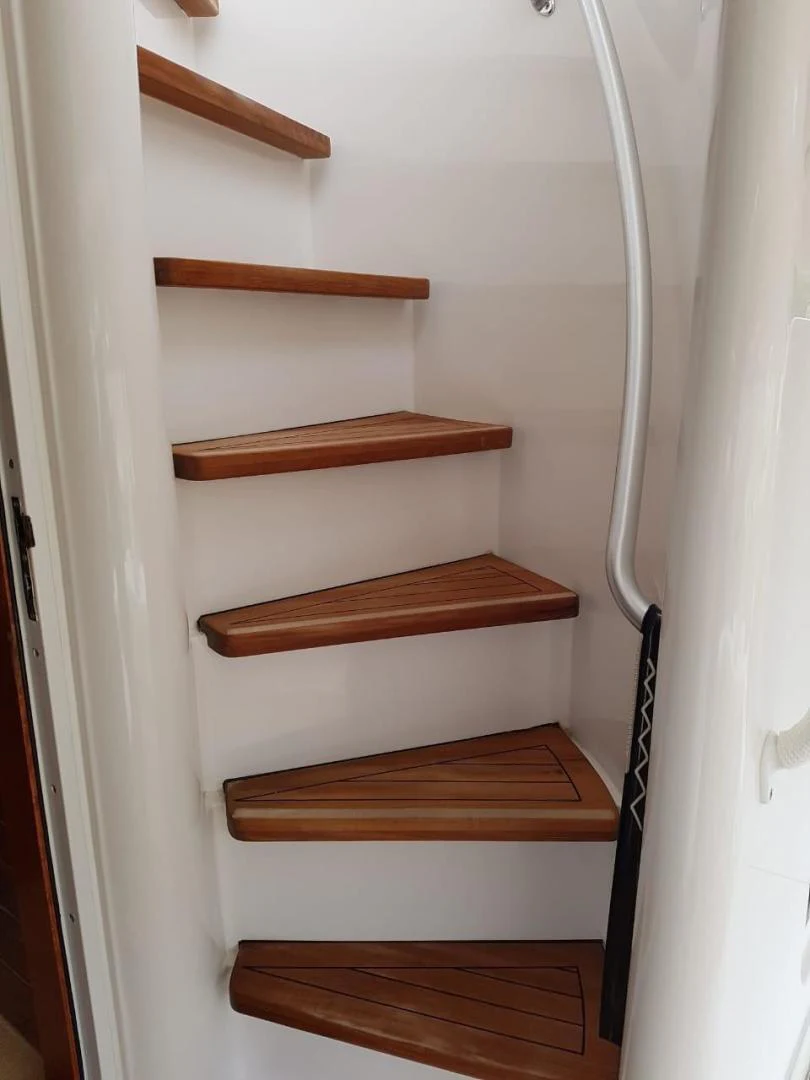 a wooden staircase with a wooden frame aboard BOUKI Yacht for Sale