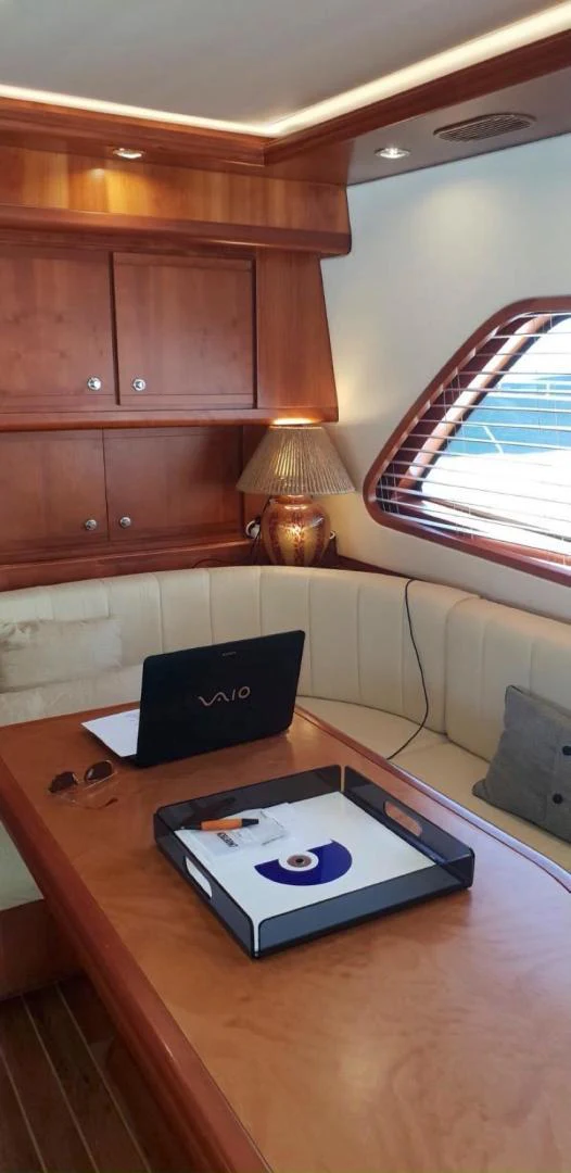 a laptop on a table aboard BOUKI Yacht for Sale
