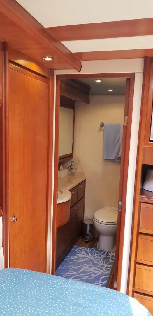a bathroom with a blue rug aboard BOUKI Yacht for Sale