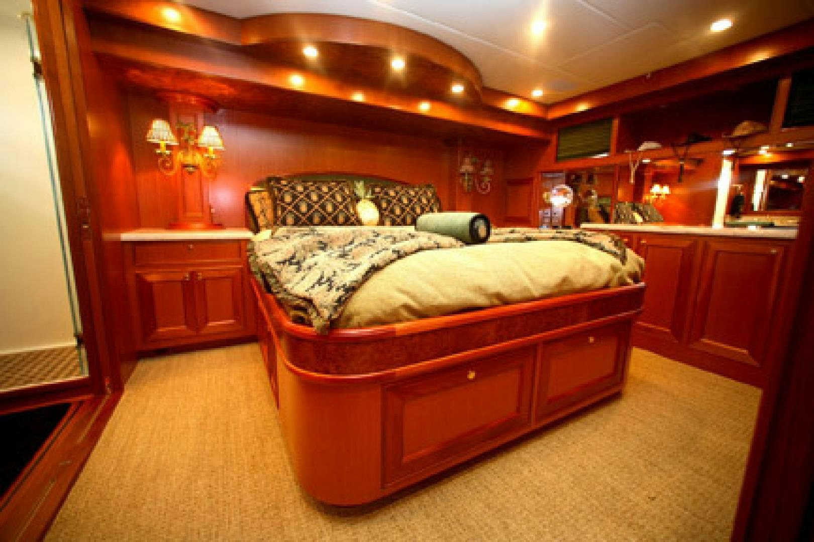 a bedroom with a bed and a desk aboard No Name Yacht for Sale