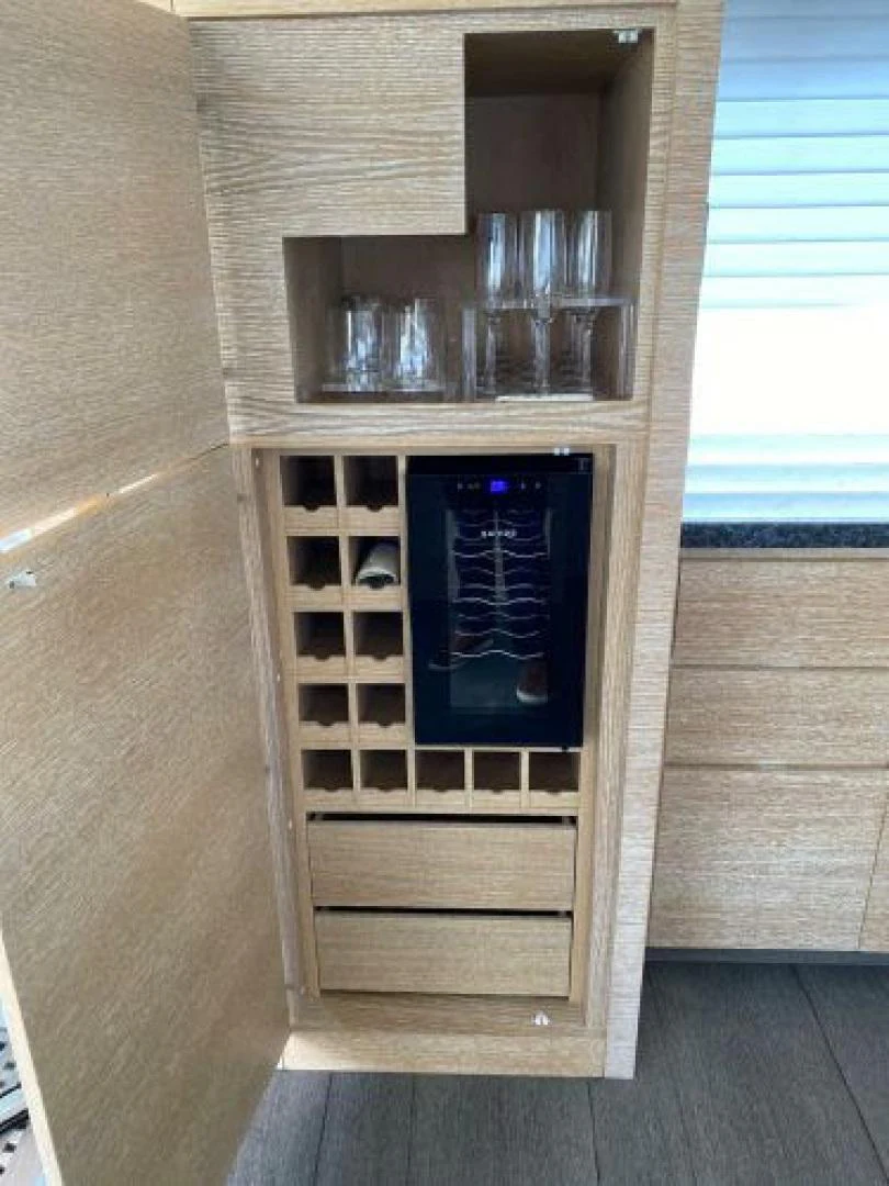 a cabinet with a glass door aboard THE ONLY BLUE 66 FLY Yacht for Sale