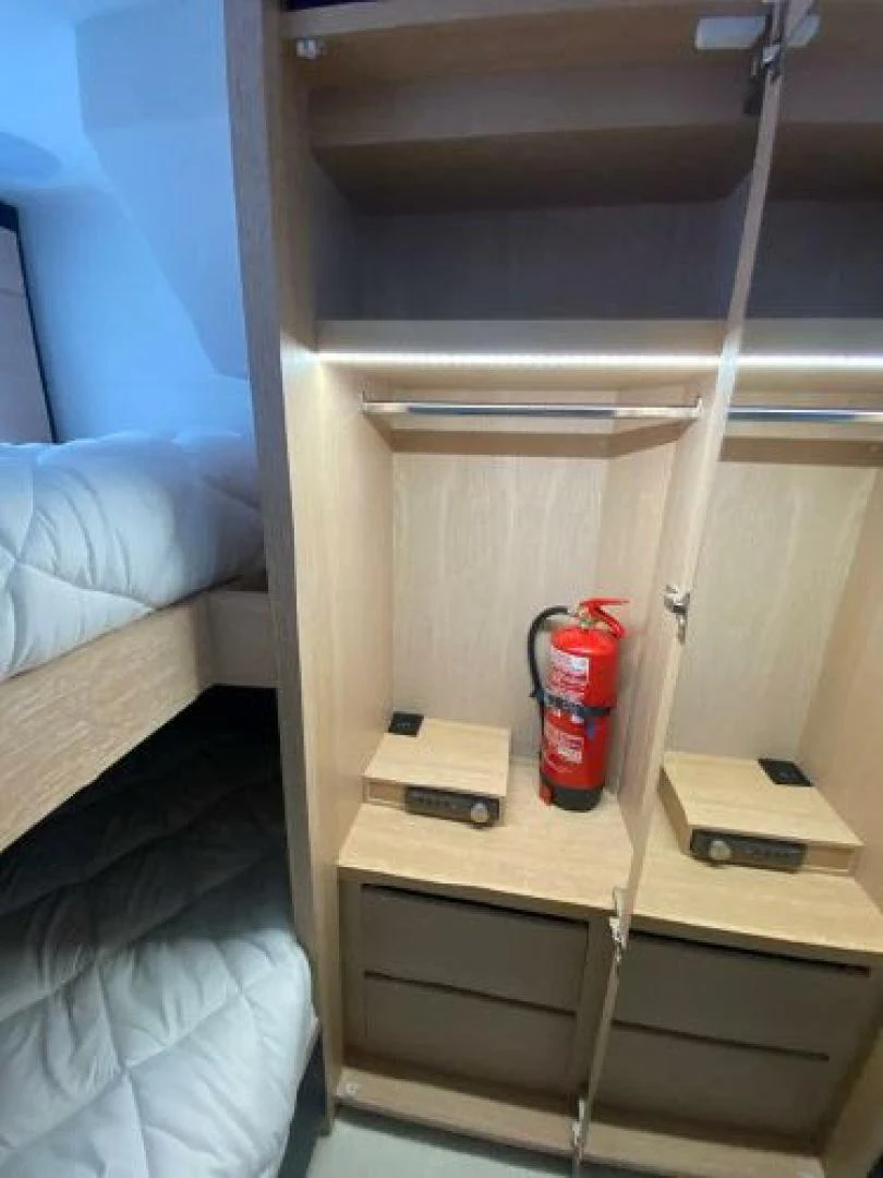 a red canister on a wooden shelf aboard THE ONLY BLUE 66 FLY Yacht for Sale