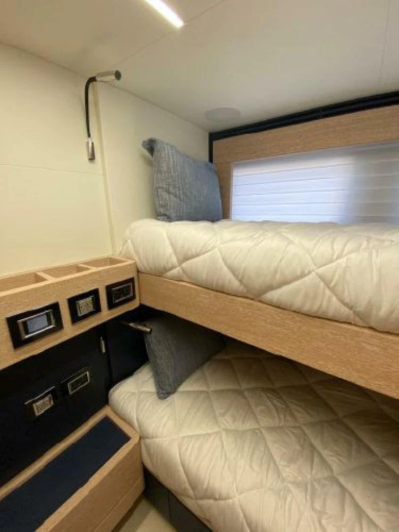 a bed with a wooden frame aboard THE ONLY BLUE 66 FLY Yacht for Sale