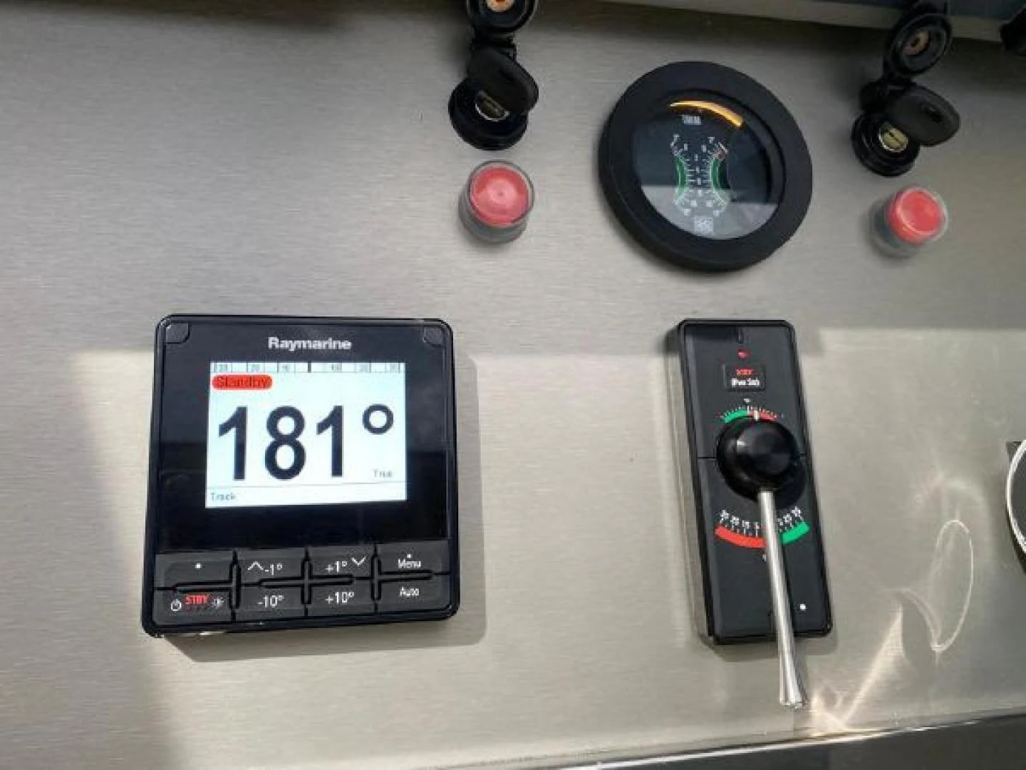 a black electronic device with a screen and a black watch aboard THE ONLY BLUE 66 FLY Yacht for Sale