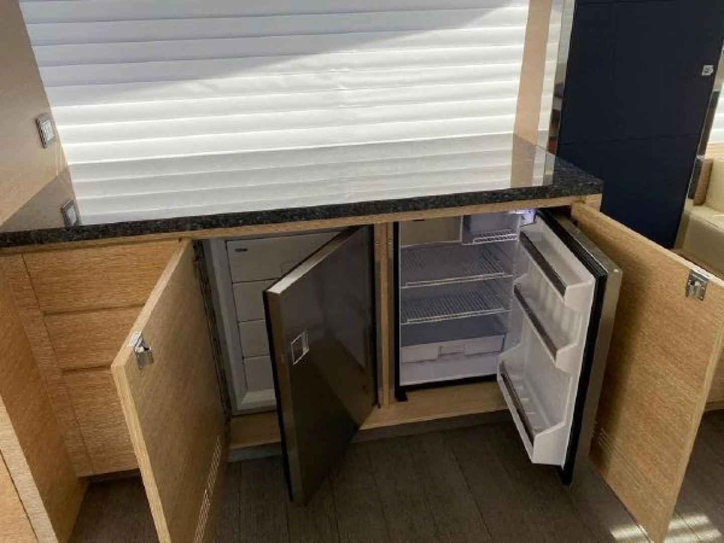 a kitchen with cabinets and appliances aboard THE ONLY BLUE 66 FLY Yacht for Sale