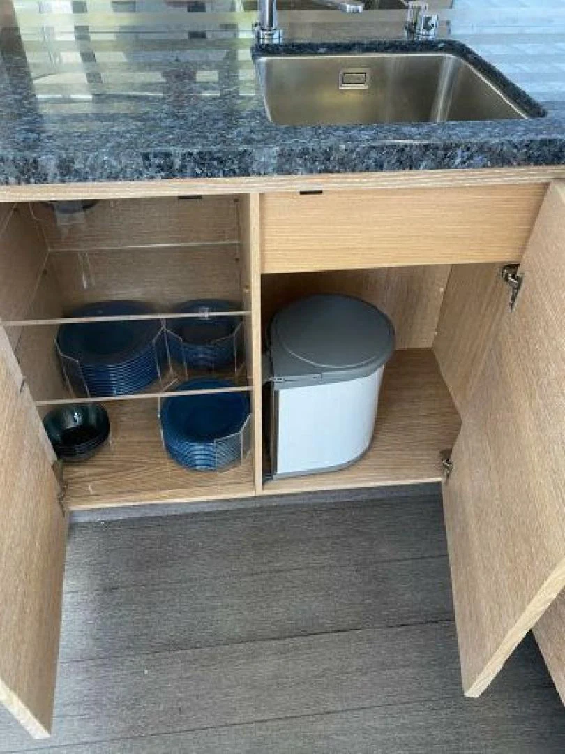 a kitchen counter with a sink and a shelf with bowls aboard THE ONLY BLUE 66 FLY Yacht for Sale