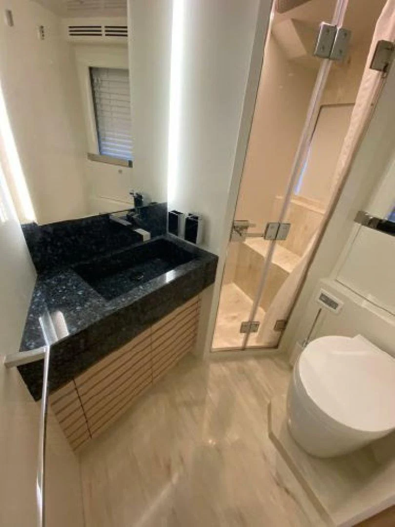 a bathroom with a shower and a toilet aboard THE ONLY BLUE 66 FLY Yacht for Sale