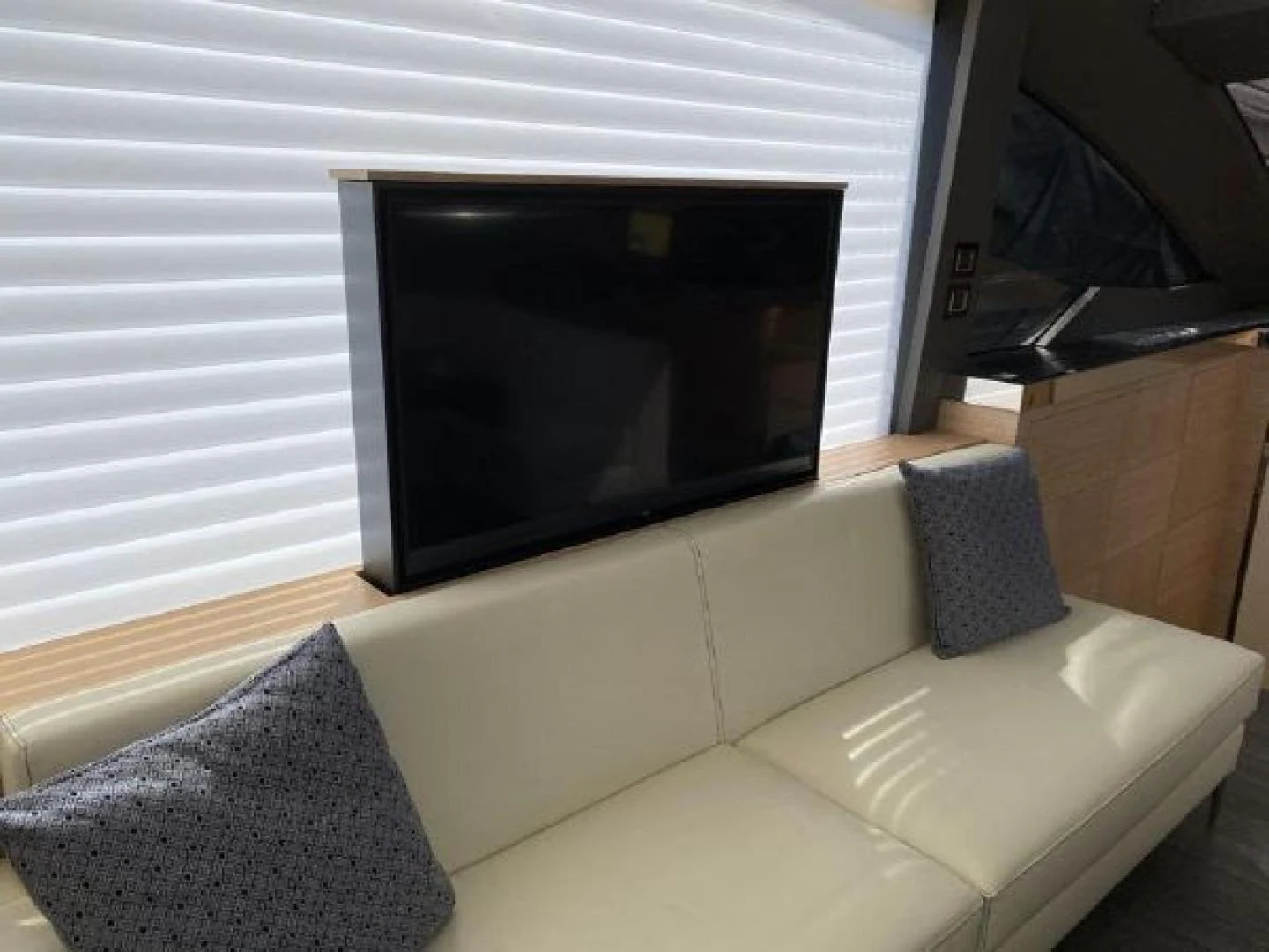 a couch and a television in a room aboard THE ONLY BLUE 66 FLY Yacht for Sale