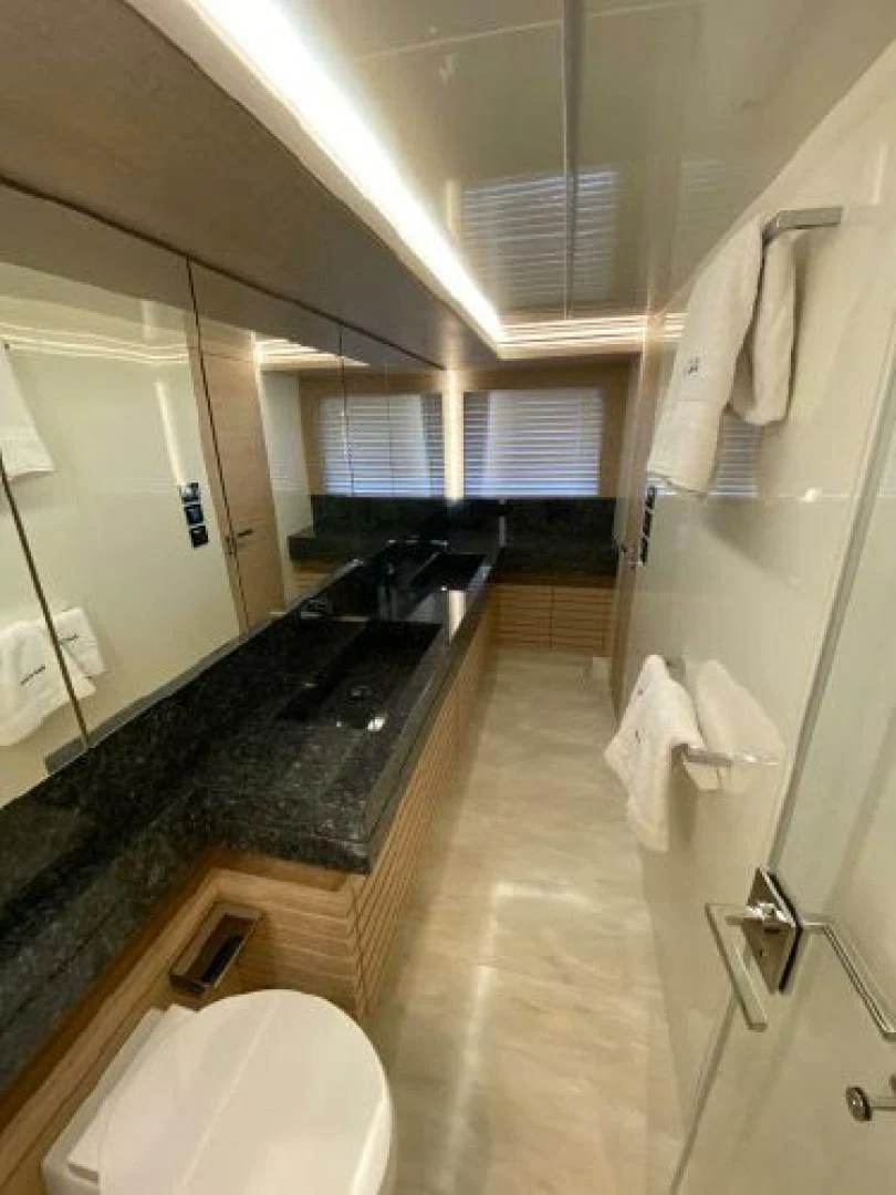 a bathroom with a large mirror aboard THE ONLY BLUE 66 FLY Yacht for Sale