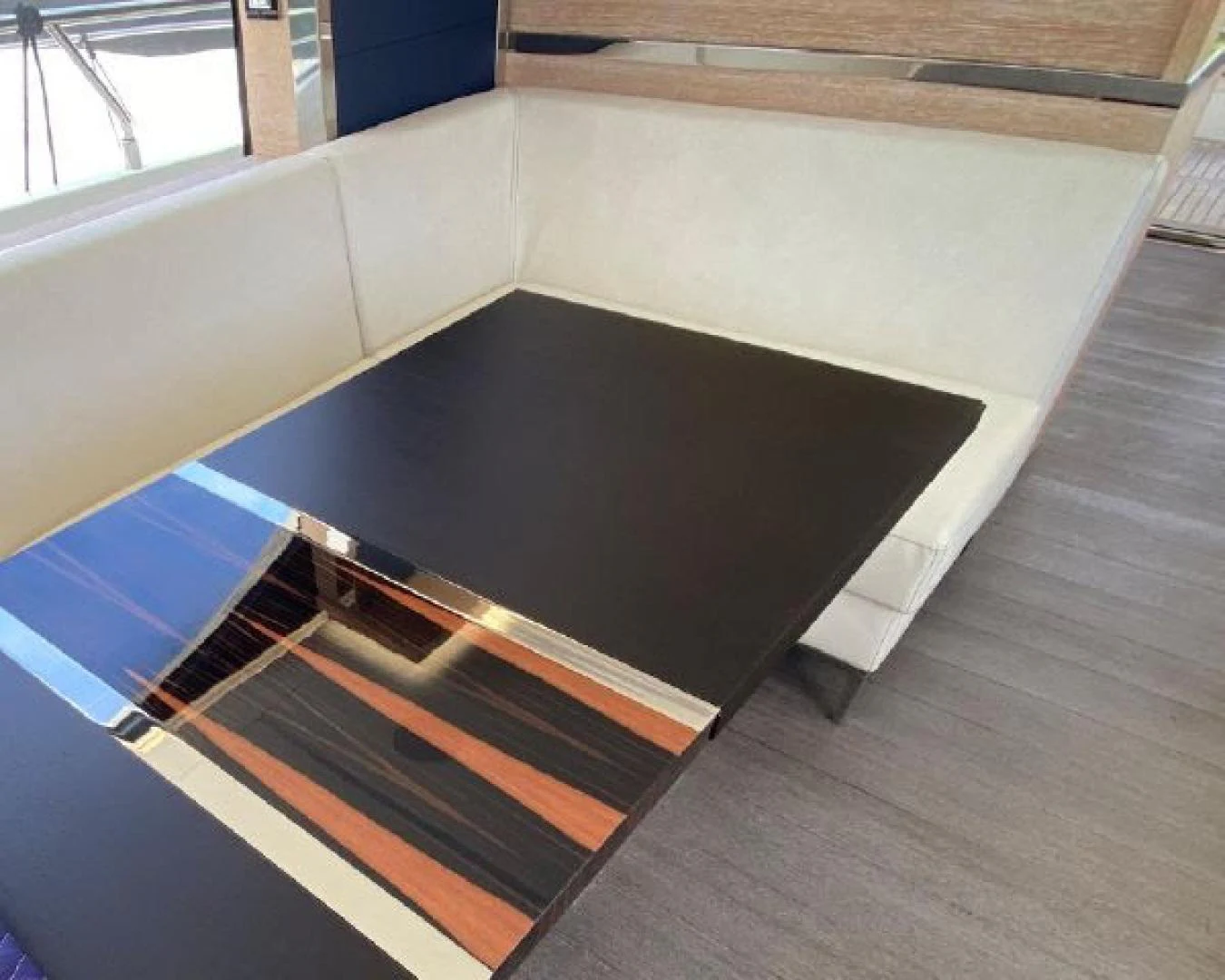 a large black rectangular object on a wooden surface aboard THE ONLY BLUE 66 FLY Yacht for Sale