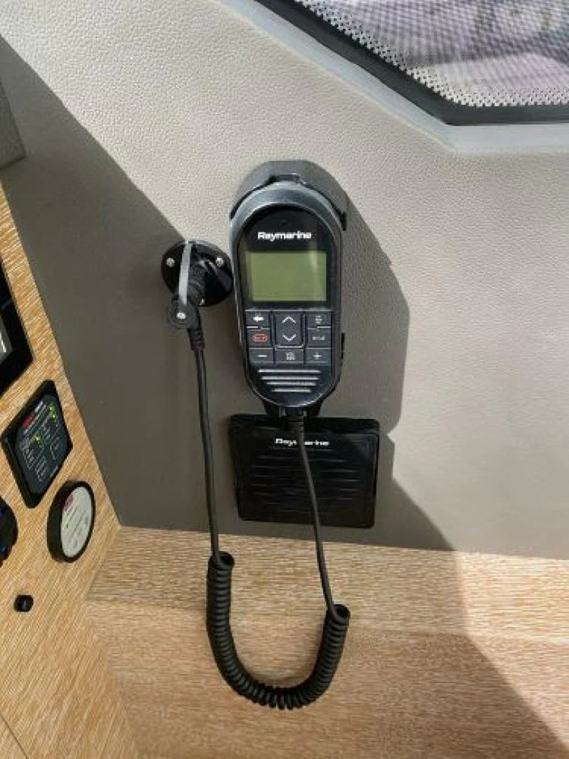 a black telephone on a wooden surface aboard THE ONLY BLUE 66 FLY Yacht for Sale