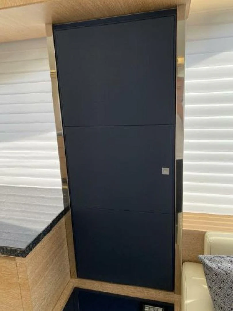 a black cabinet with a white door aboard THE ONLY BLUE 66 FLY Yacht for Sale
