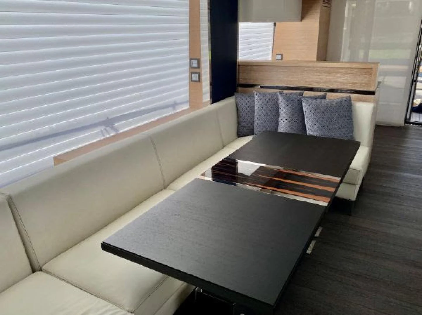 a couch and coffee table aboard THE ONLY BLUE 66 FLY Yacht for Sale
