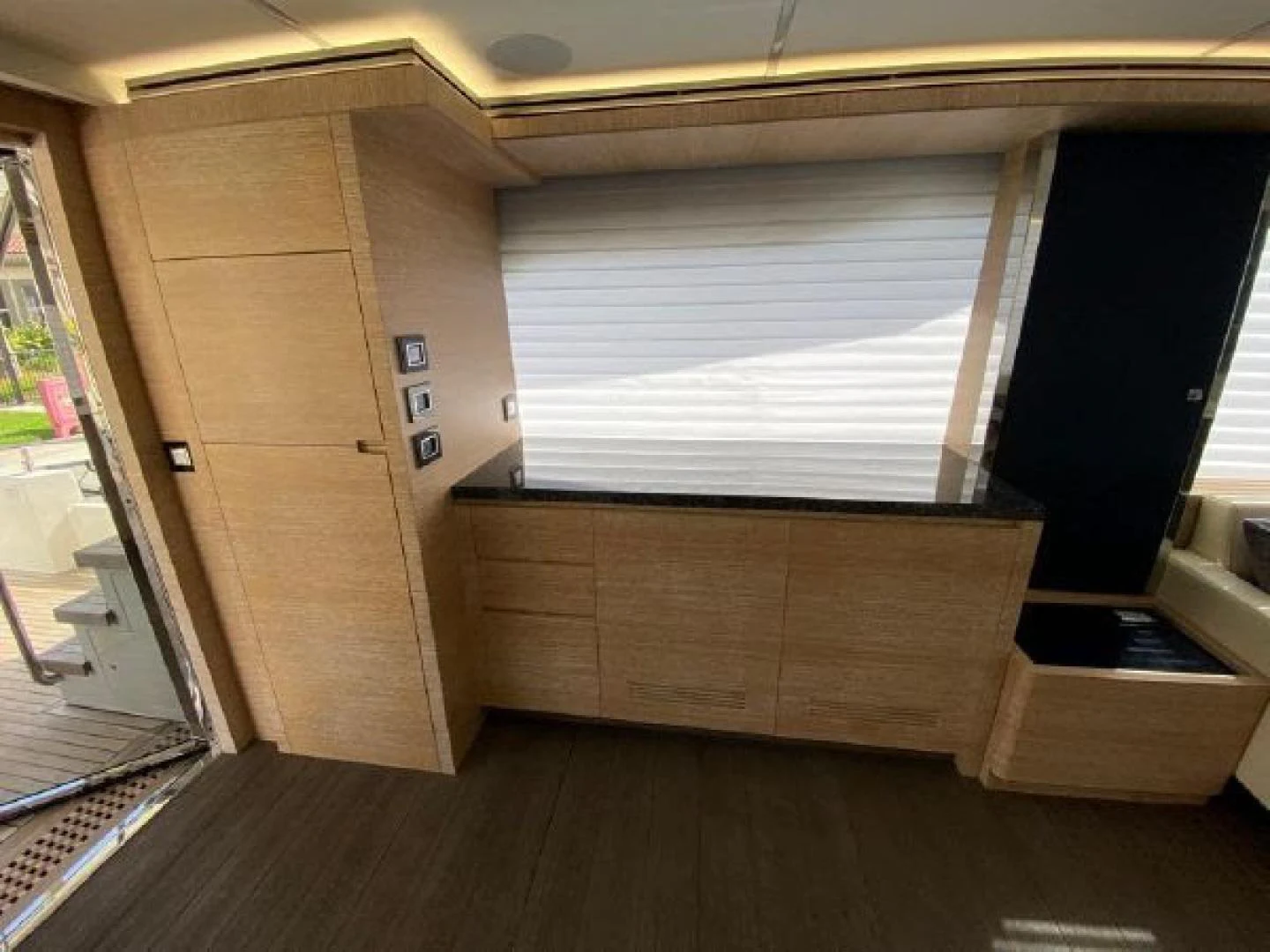 a room with a wood floor and a window aboard THE ONLY BLUE 66 FLY Yacht for Sale