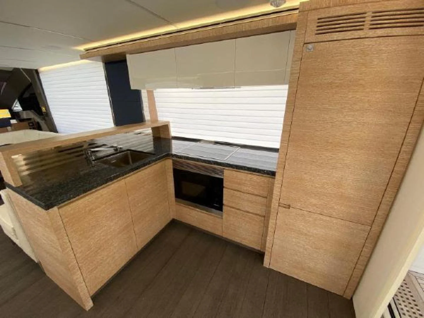 a kitchen with a sink and cabinets aboard THE ONLY BLUE 66 FLY Yacht for Sale
