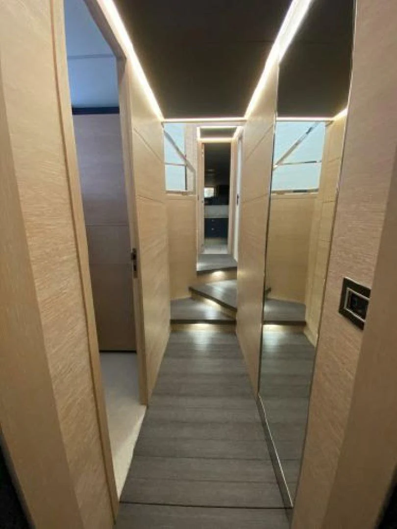 a long hallway with doors aboard THE ONLY BLUE 66 FLY Yacht for Sale