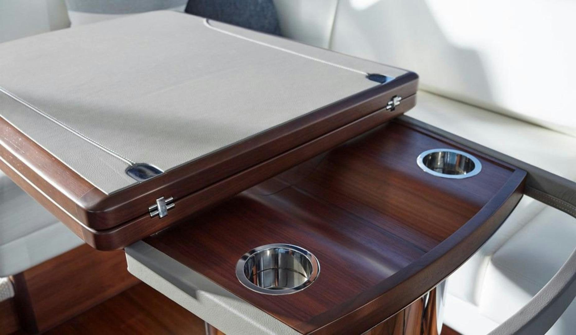 a wooden table with a silver plate aboard Namaste Yacht for Sale