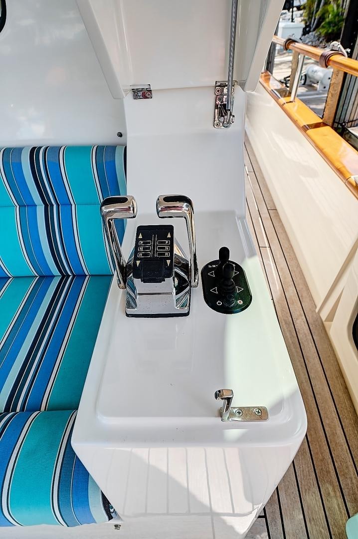 a white bathtub with a faucet and a black object on the side aboard JOAN'S RONDEVOUS Yacht for Sale