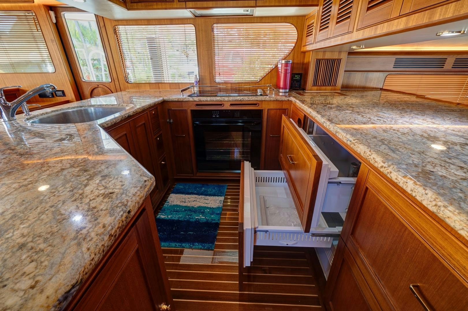 a kitchen with wooden cabinets aboard JOAN'S RONDEVOUS Yacht for Sale