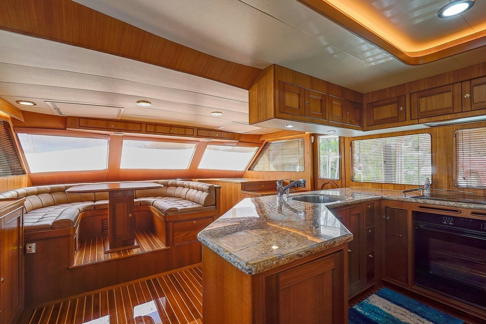 a kitchen with wooden cabinets aboard JOAN'S RONDEVOUS Yacht for Sale