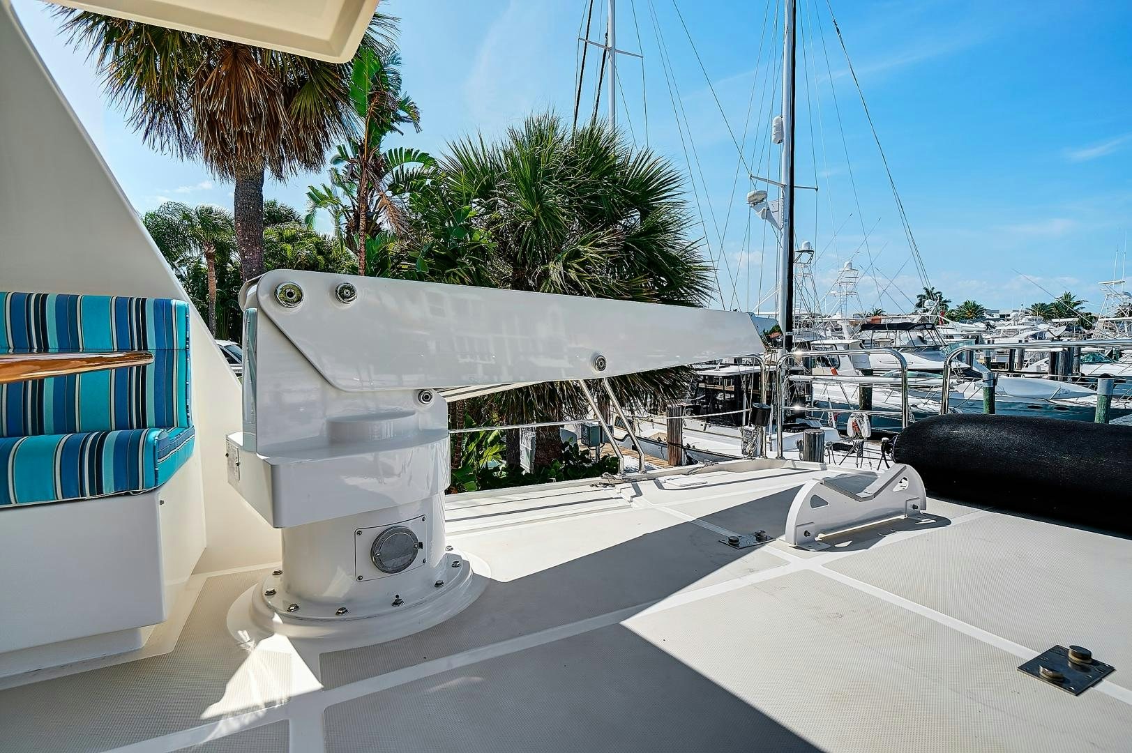 a white boat on a dock aboard JOAN'S RONDEVOUS Yacht for Sale
