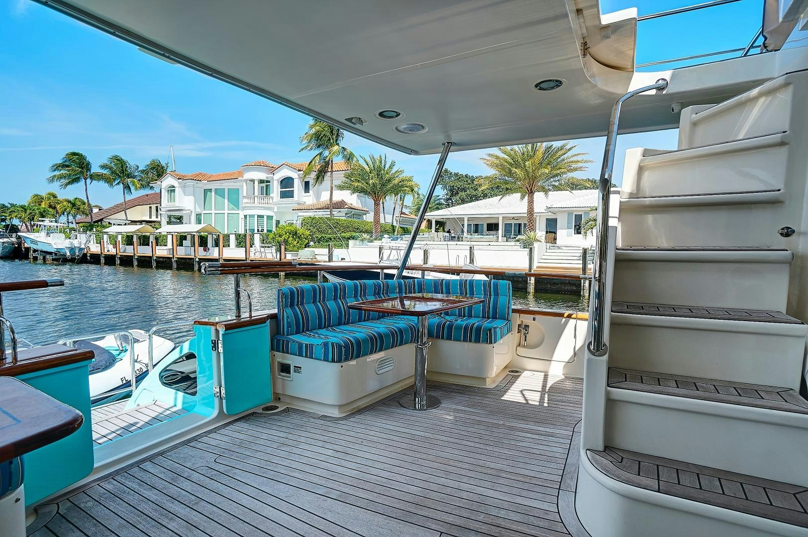 a deck with a pool and a deck with boats and trees aboard JOAN'S RONDEVOUS Yacht for Sale