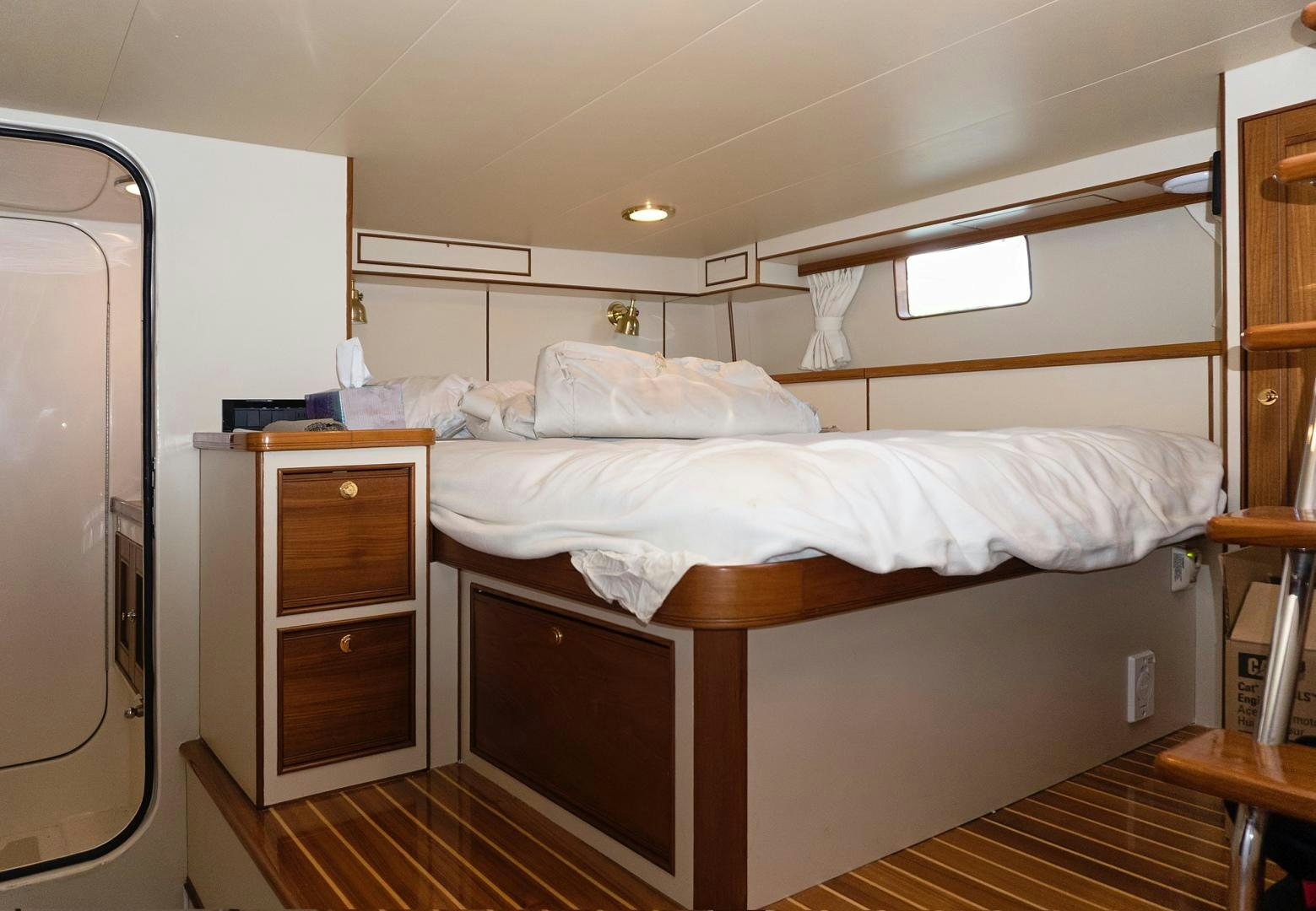 a bedroom with a bed and a closet aboard JOAN'S RONDEVOUS Yacht for Sale