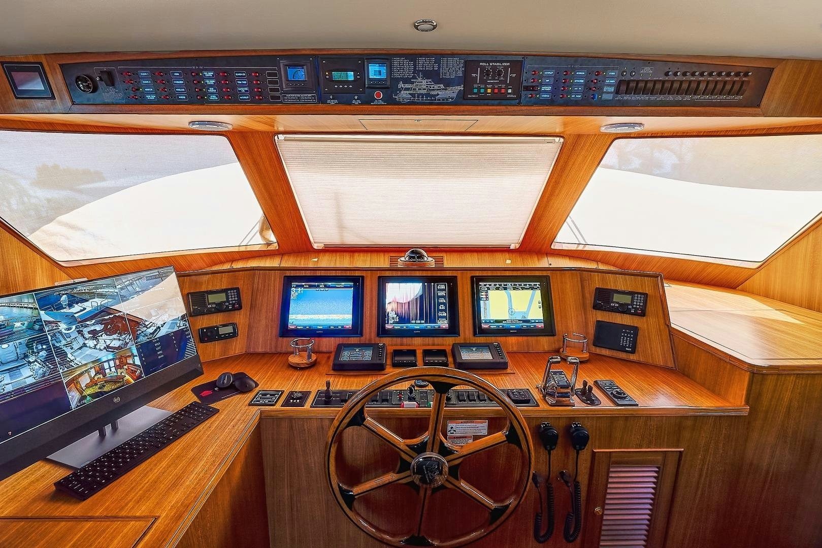 a control panel with multiple monitors aboard JOAN'S RONDEVOUS Yacht for Sale