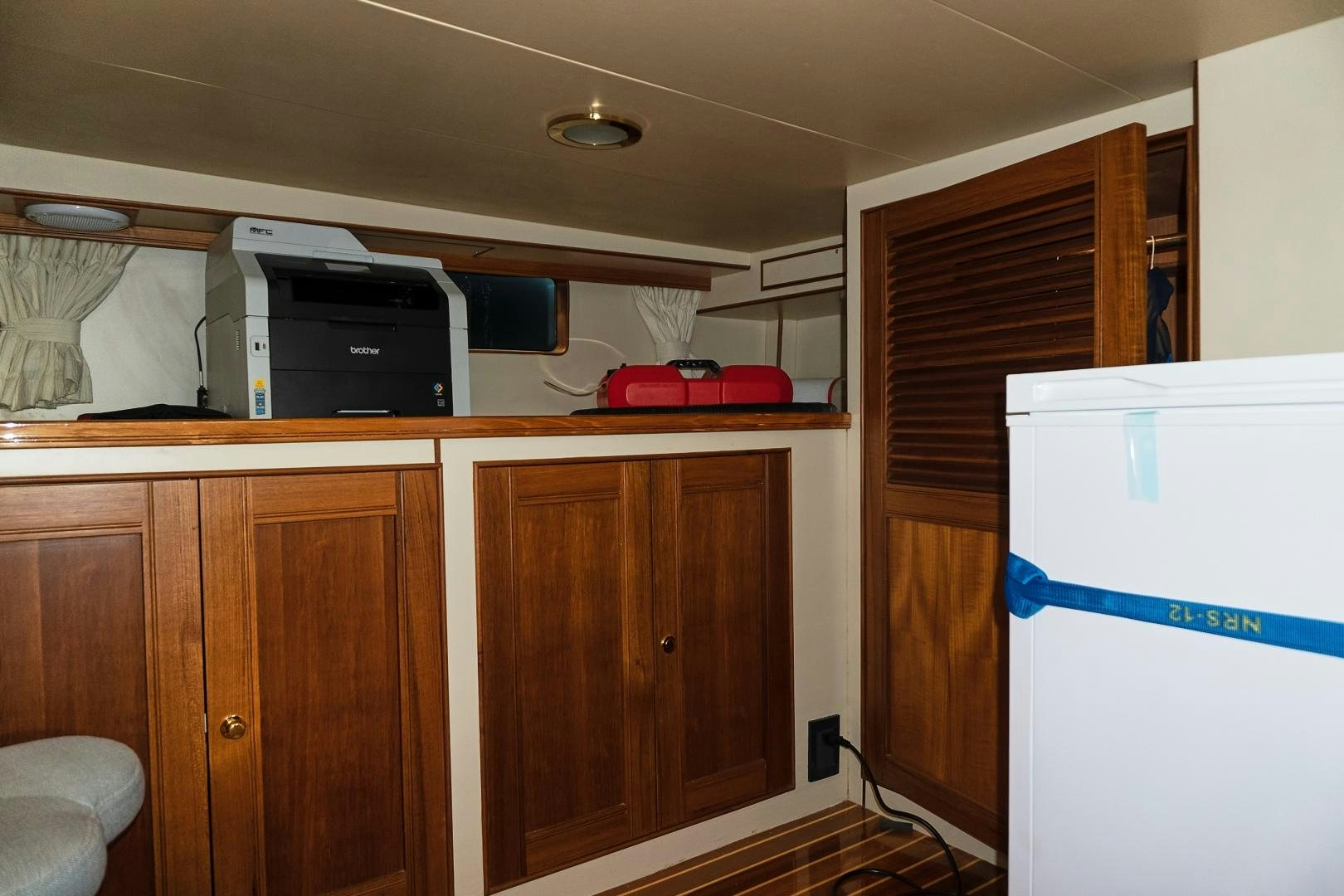 a kitchen with a refrigerator and microwave aboard JOAN'S RONDEVOUS Yacht for Sale