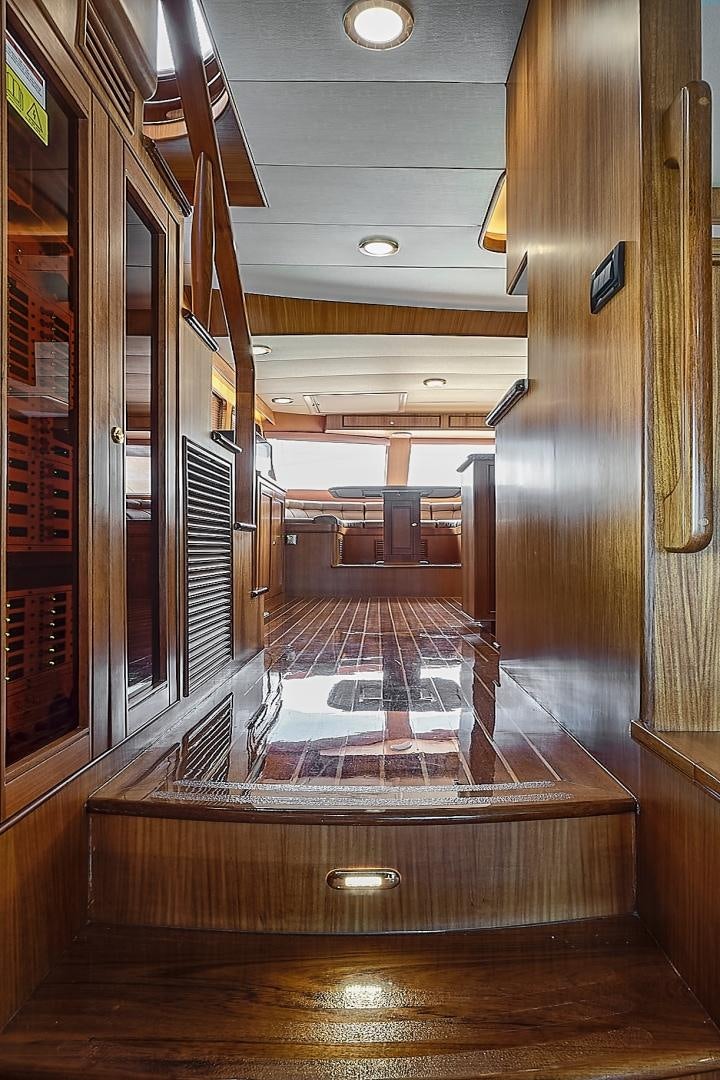 a hallway with a wood door aboard JOAN'S RONDEVOUS Yacht for Sale