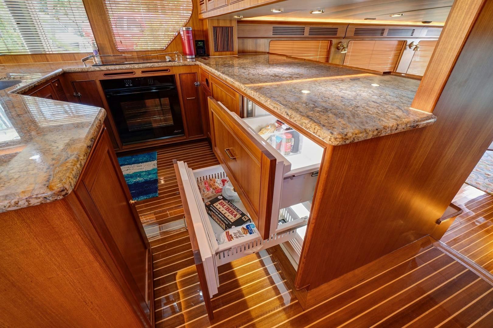 a kitchen with a counter and cabinets aboard JOAN'S RONDEVOUS Yacht for Sale