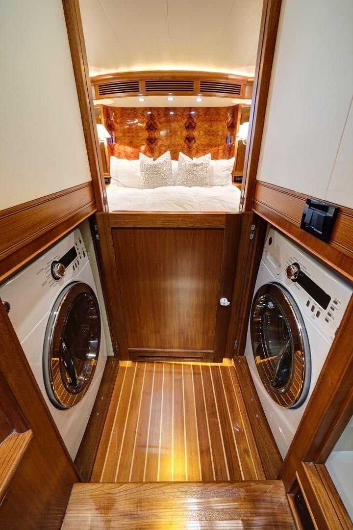 a room with a washing machine and a bed aboard JOAN'S RONDEVOUS Yacht for Sale