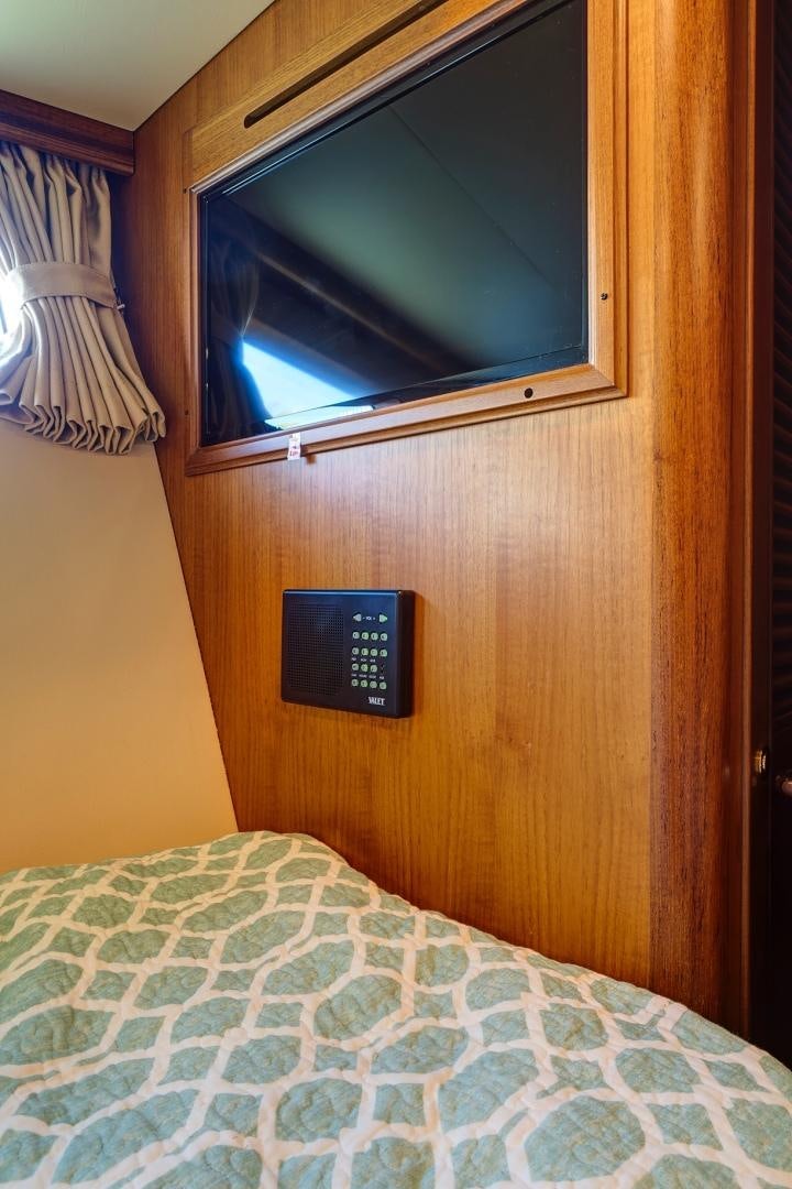 a bed with a blue blanket aboard JOAN'S RONDEVOUS Yacht for Sale