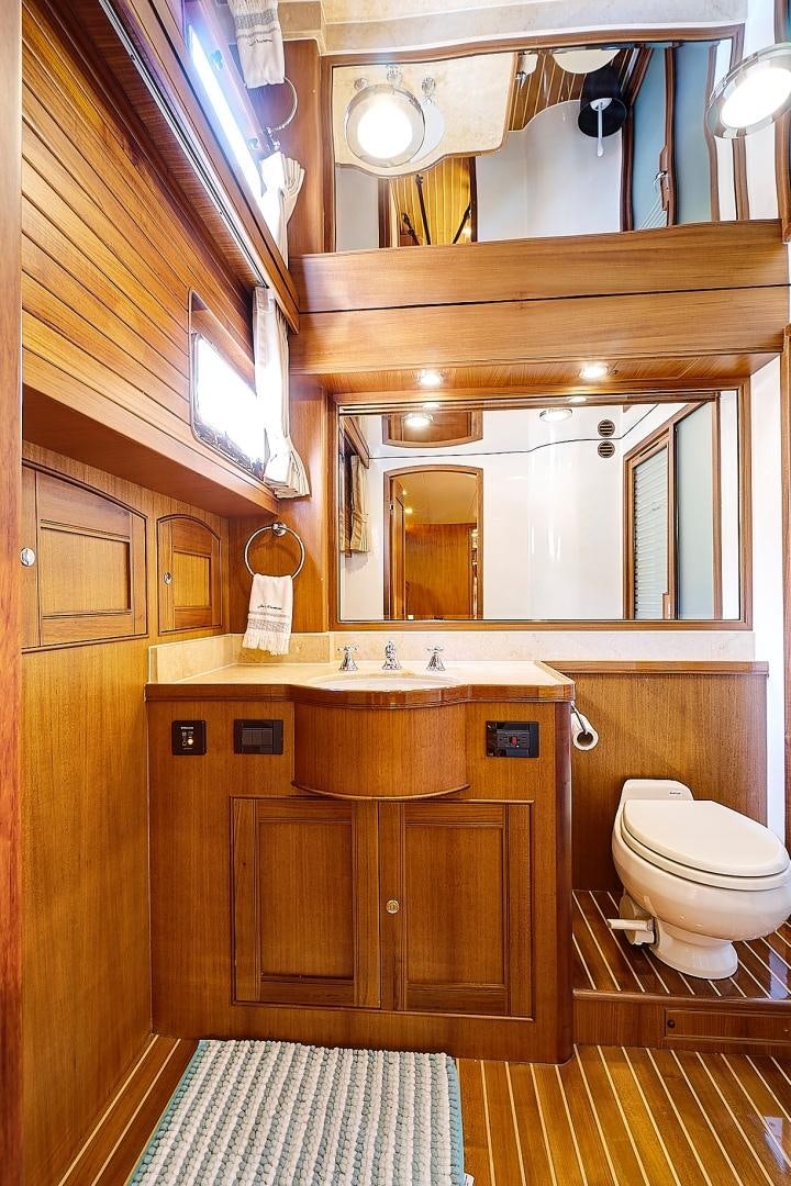 a bathroom with wooden cabinets aboard JOAN'S RONDEVOUS Yacht for Sale