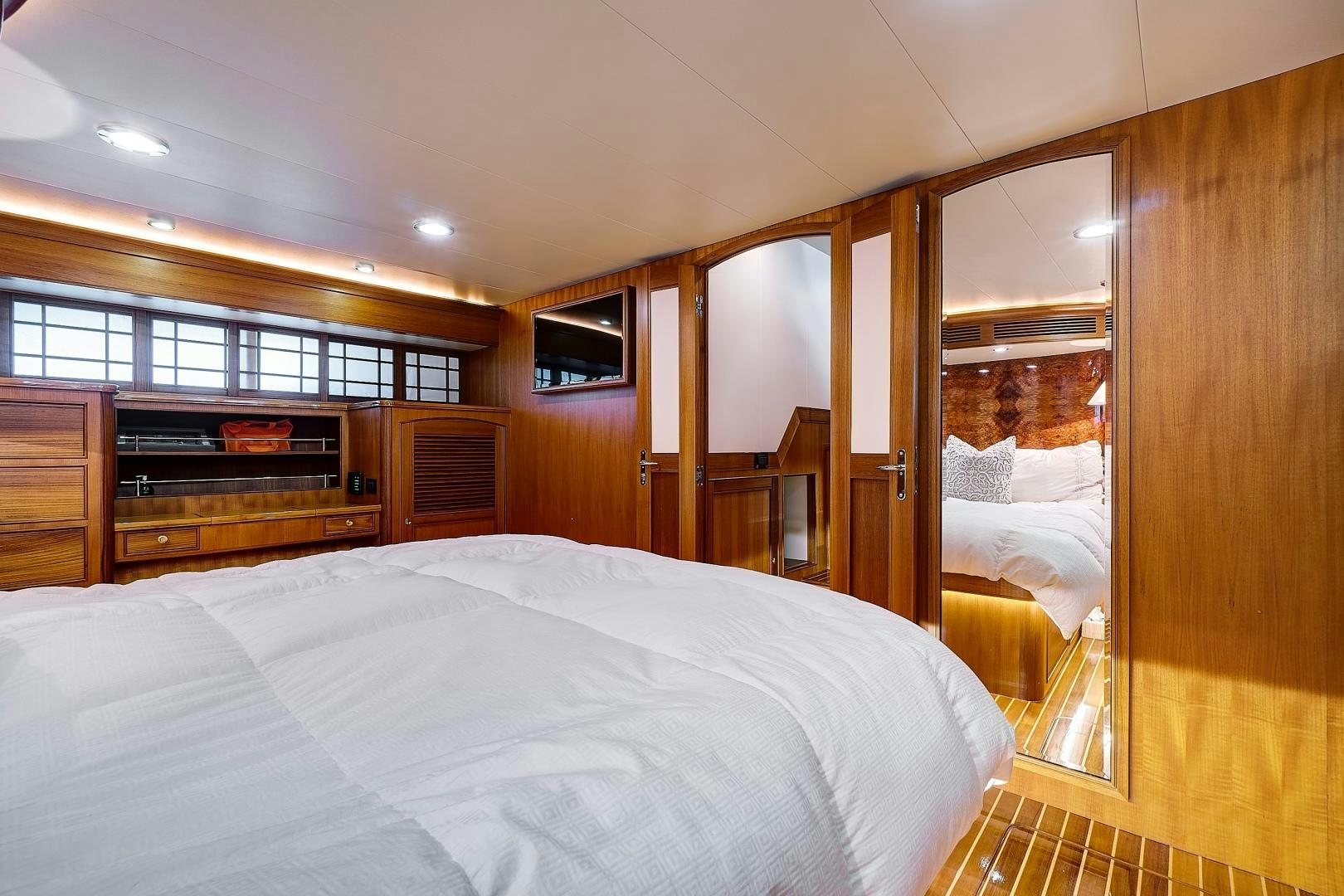 a bedroom with a wood cabinet aboard JOAN'S RONDEVOUS Yacht for Sale